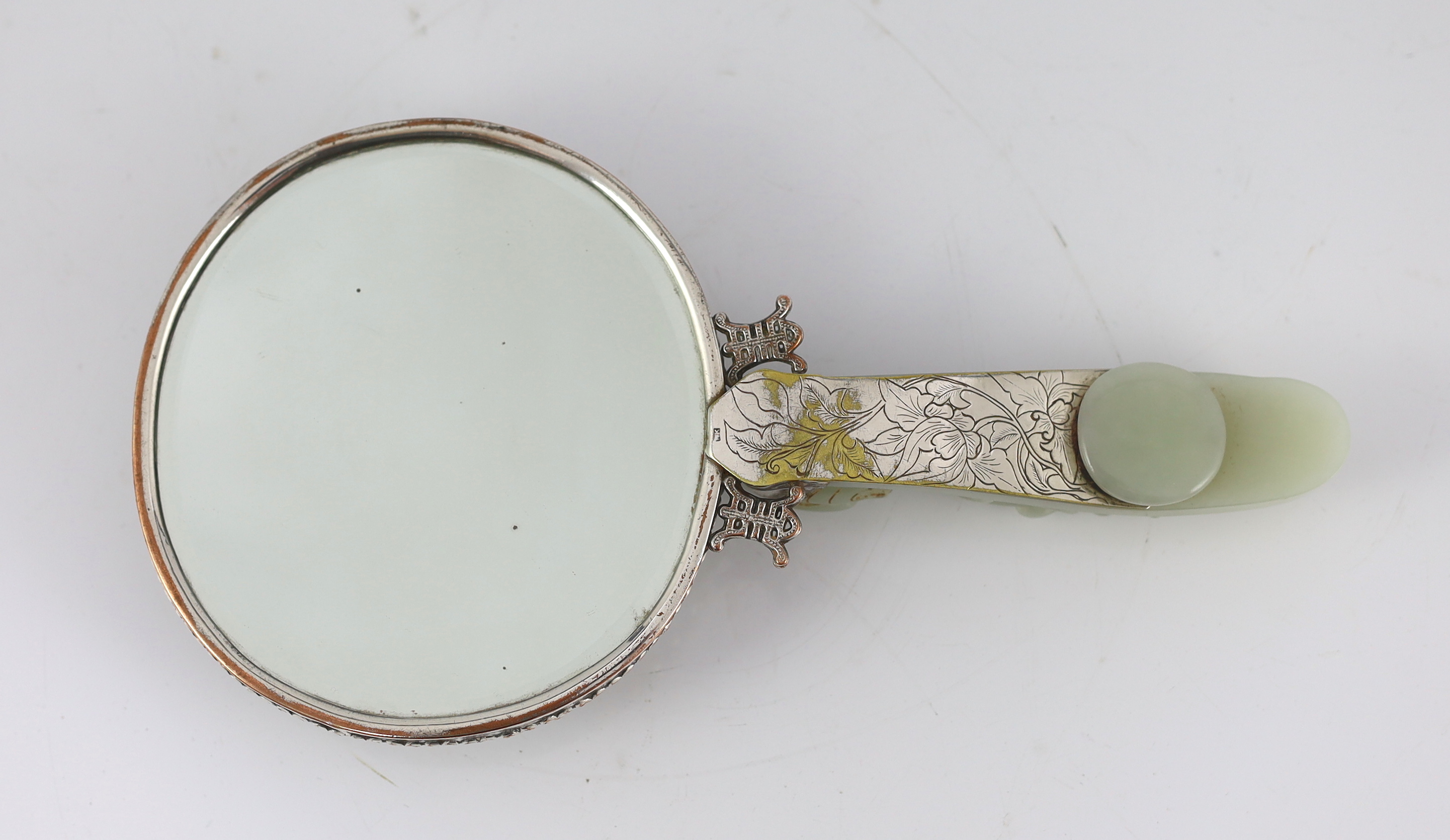 An early 20th century Chinese plated hand mirror with 18th/19th century jade mounts